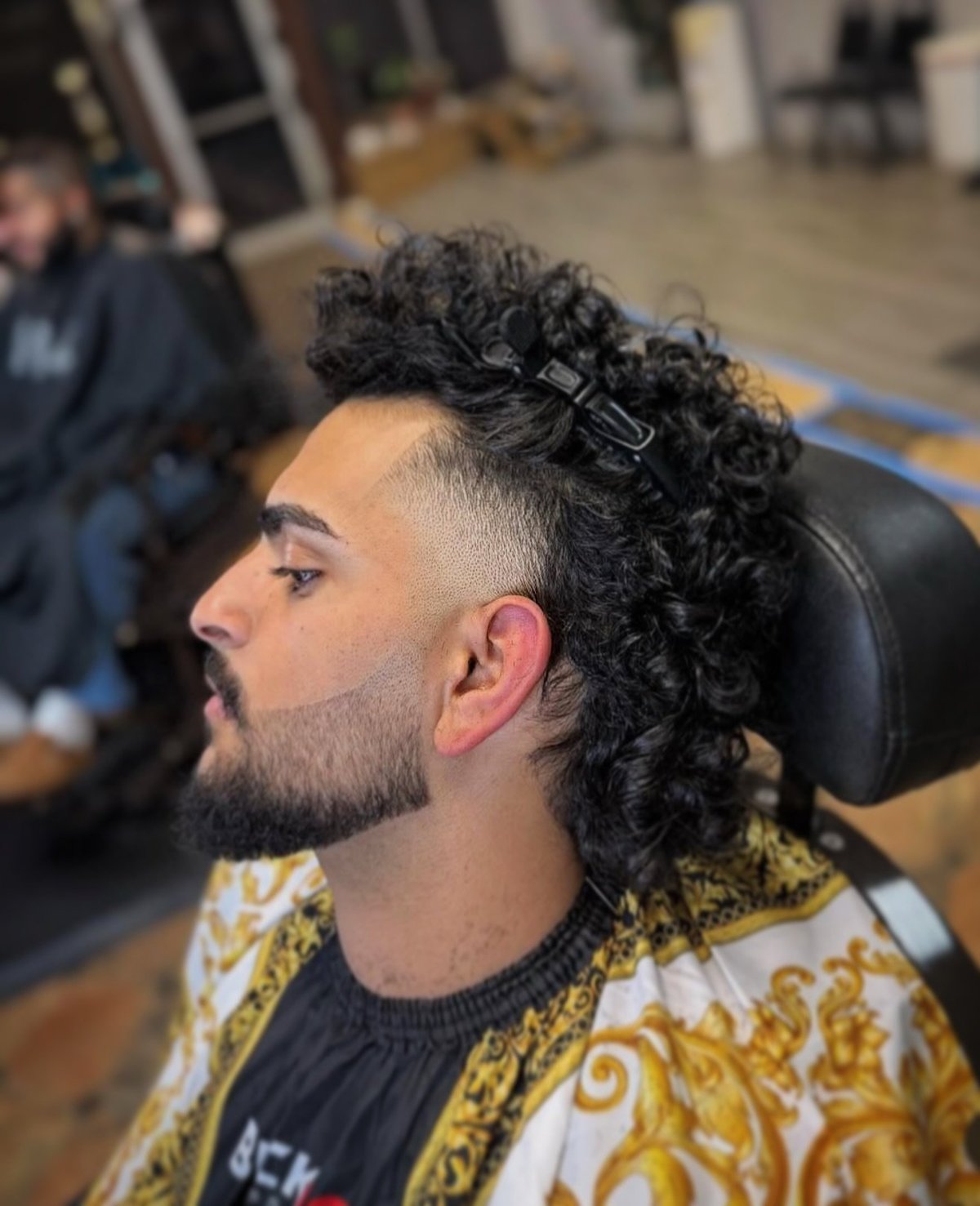 Studio Blends client with a fresh mid-fade and styled curls